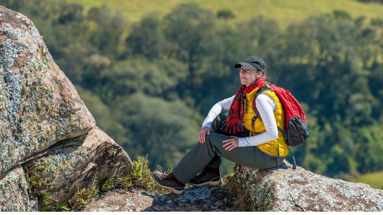 A woman wearing hiking clothes and boots