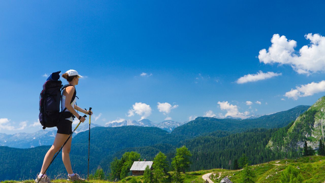 a person hiking on a clear sunning day with summer clothing on