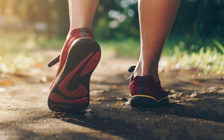 A woman wearing walking shoes with wide toe box