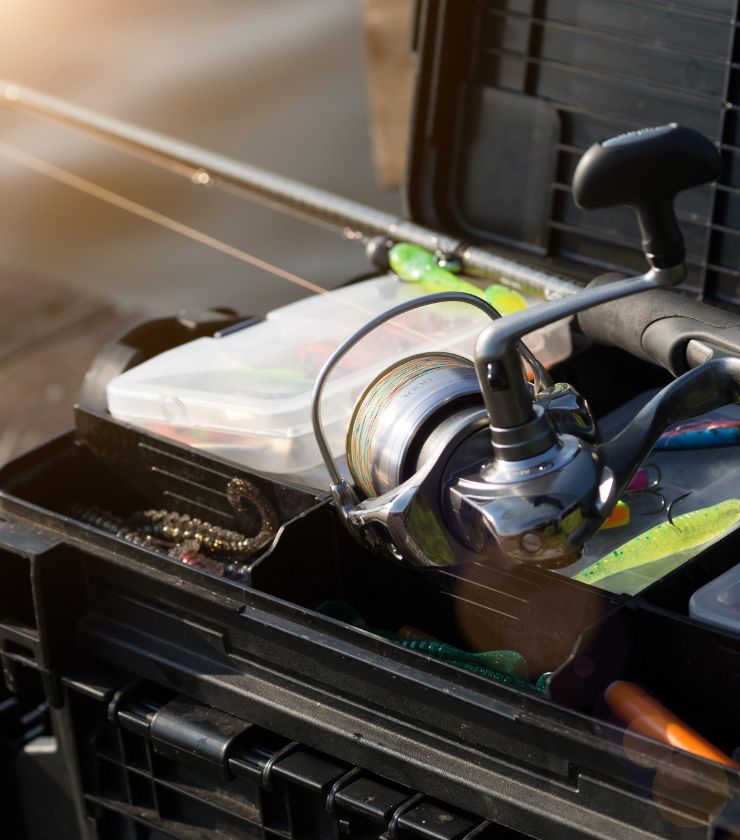 A fishing pole and tackle box, essential for any fisherman