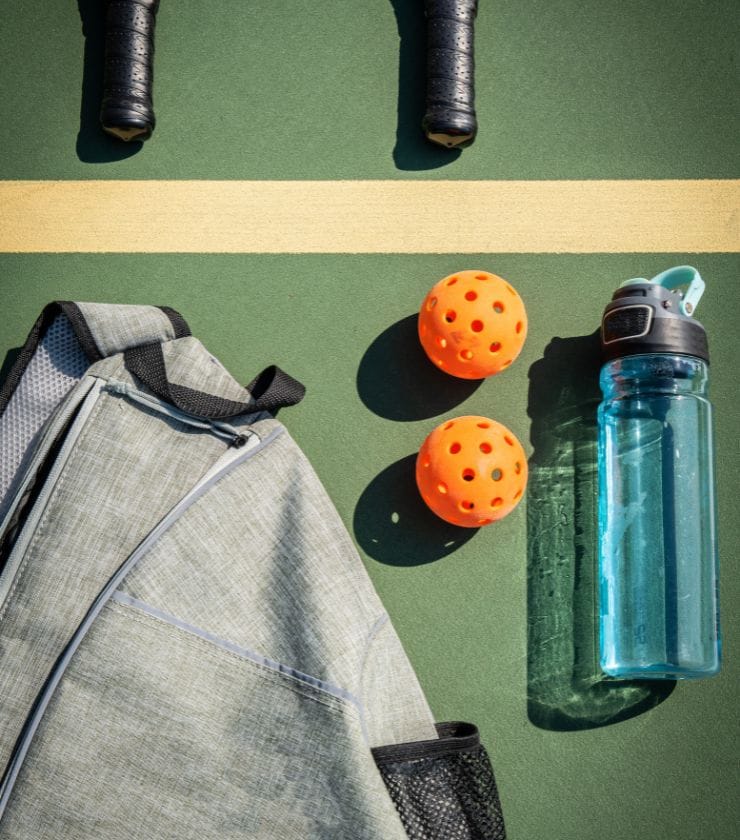 pickleball bag, balls, water bottle and paddles