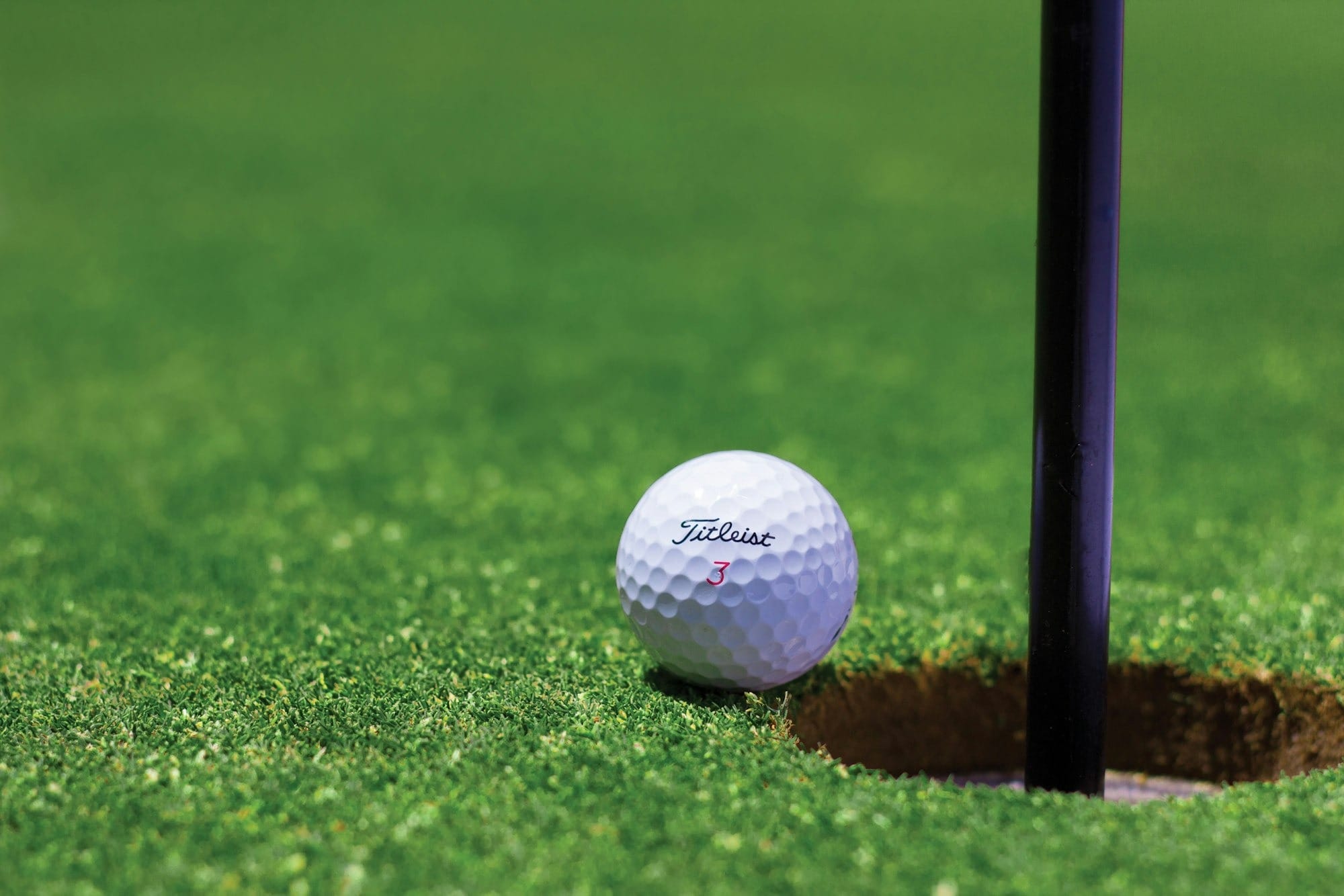 white golf ball on green grass field during daytime - what's the best golf balls